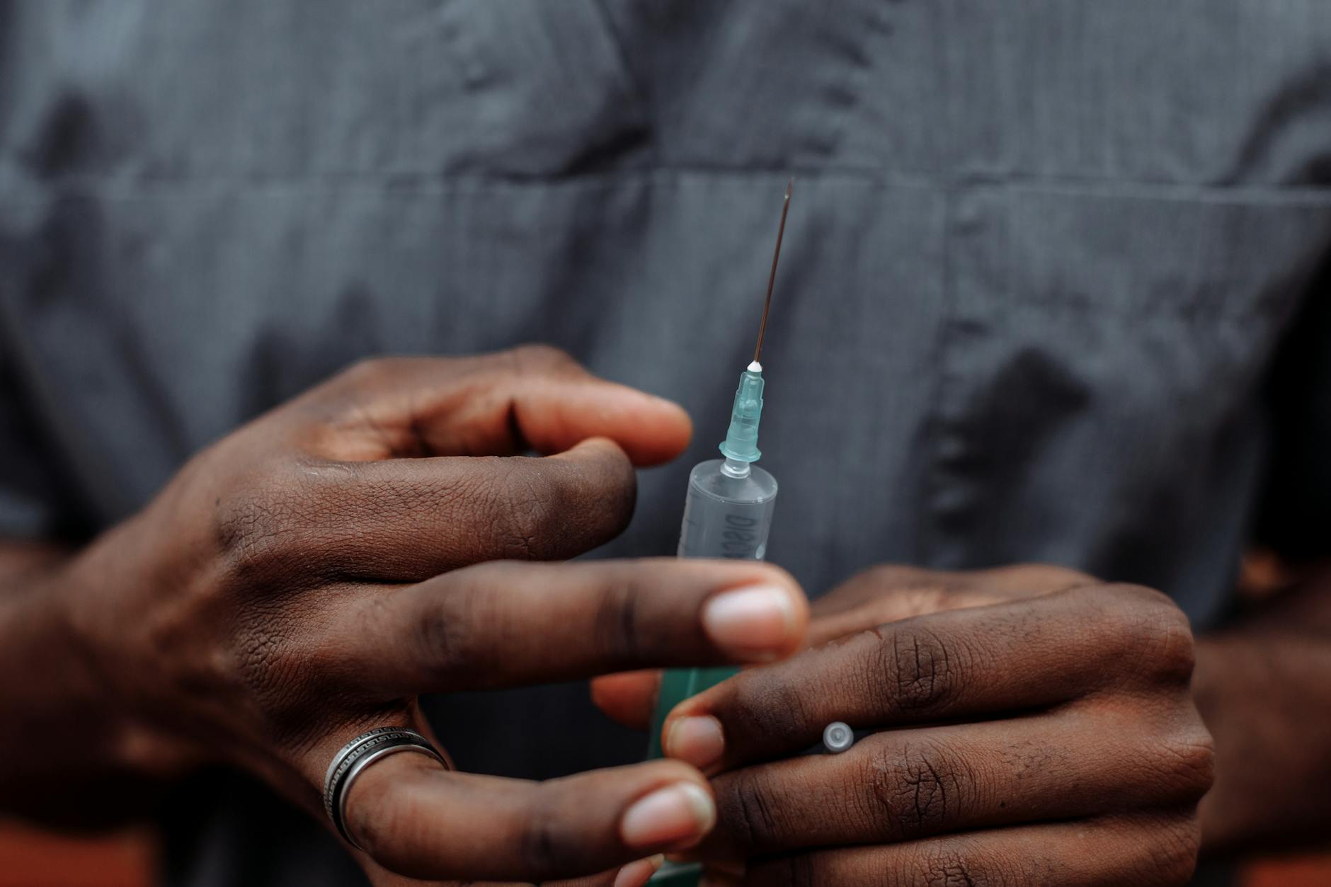 a person holding a syringe with needle